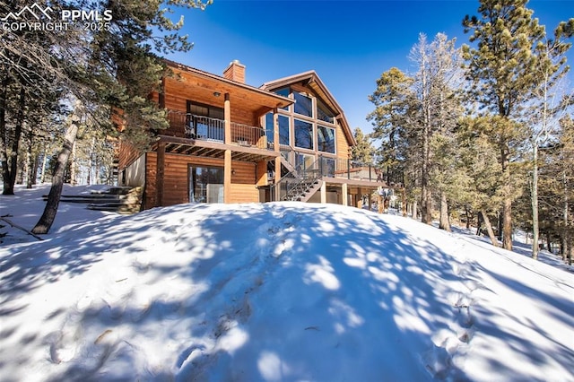 snow covered house with a balcony