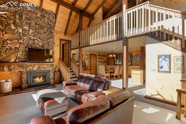 living room featuring wooden ceiling, wood walls, high vaulted ceiling, a fireplace, and beam ceiling