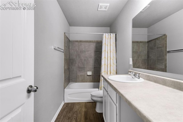 full bathroom with vanity, hardwood / wood-style floors, shower / bath combo, and toilet