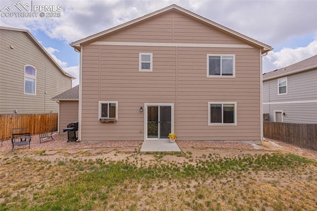 rear view of property featuring a yard and a patio