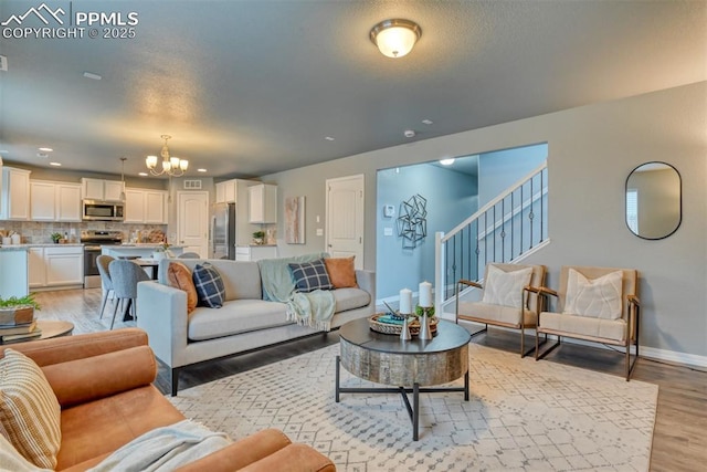 living room featuring an inviting chandelier and light wood-type flooring