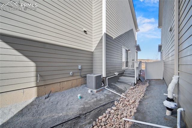 view of side of property featuring central air condition unit