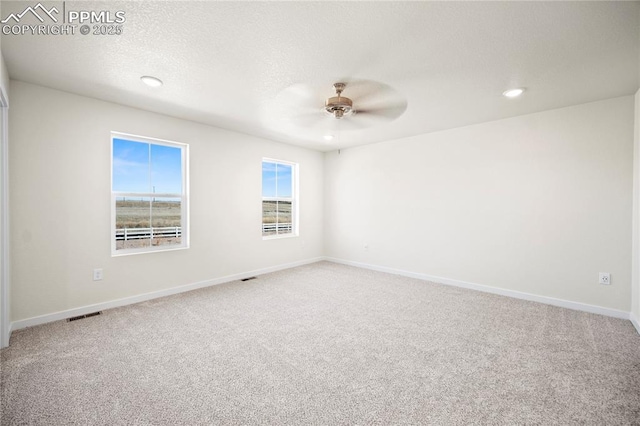 empty room featuring carpet flooring and ceiling fan