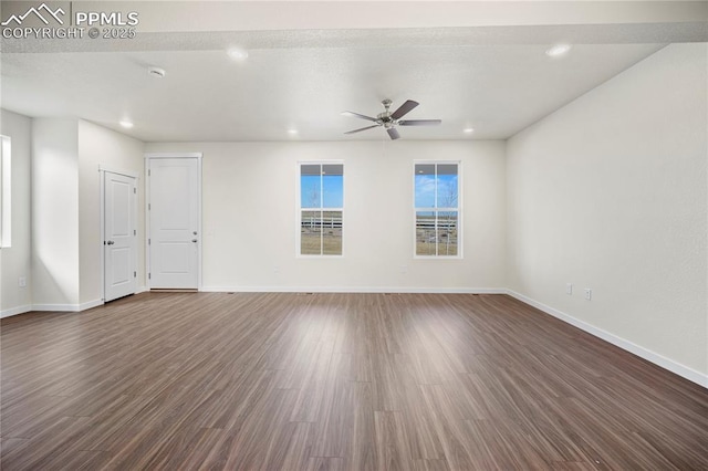 unfurnished room featuring dark hardwood / wood-style flooring and ceiling fan