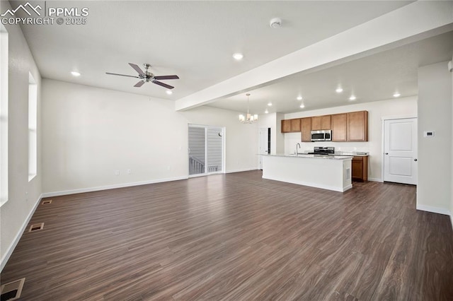 unfurnished living room with beam ceiling, sink, ceiling fan with notable chandelier, and dark hardwood / wood-style floors