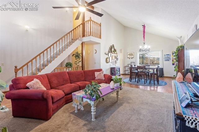 living room featuring hardwood / wood-style floors, ceiling fan with notable chandelier, and high vaulted ceiling