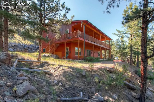 rear view of property featuring a deck