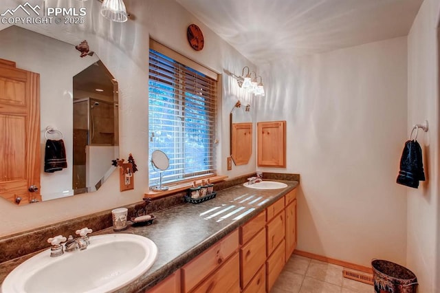 bathroom featuring tile patterned flooring, vanity, and a shower with shower door