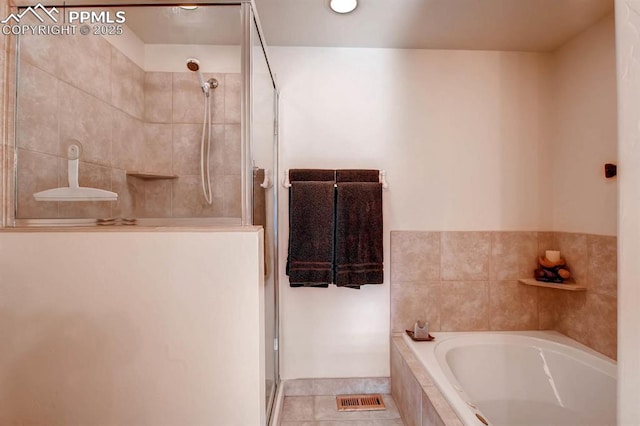 bathroom featuring tile patterned floors and independent shower and bath