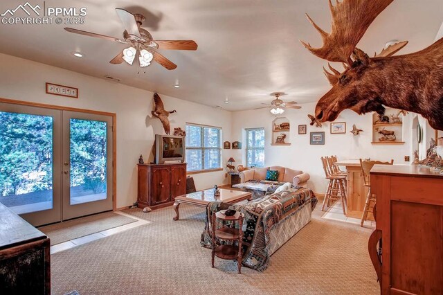 carpeted living room with ceiling fan