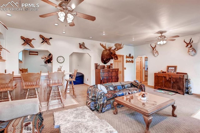 living room featuring light colored carpet and ceiling fan