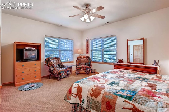 carpeted bedroom with multiple windows and ceiling fan