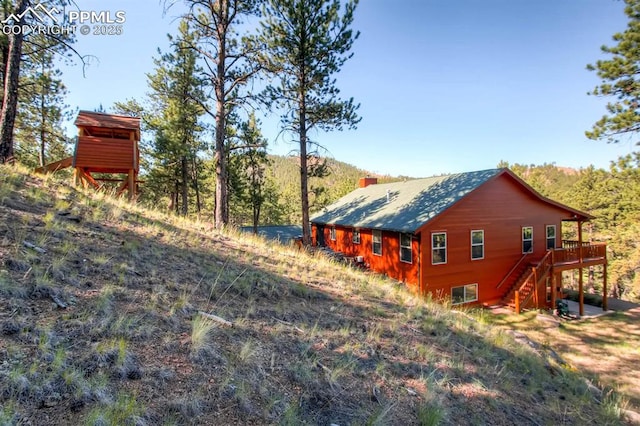 view of property exterior featuring a deck