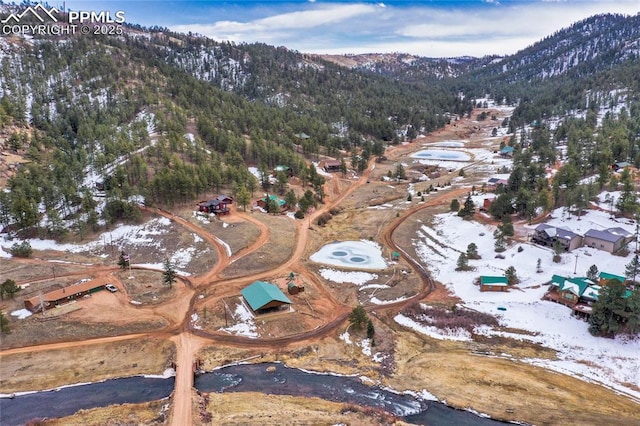 snowy aerial view featuring a mountain view