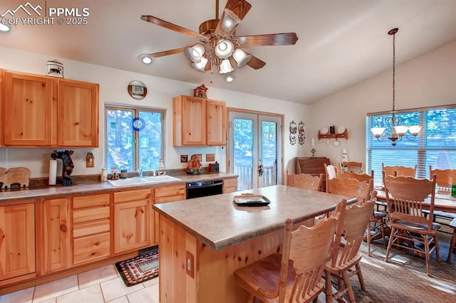 kitchen with dishwasher, a center island, a healthy amount of sunlight, decorative light fixtures, and vaulted ceiling