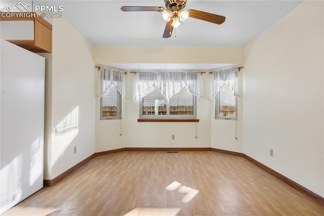 unfurnished room with ceiling fan and light hardwood / wood-style flooring