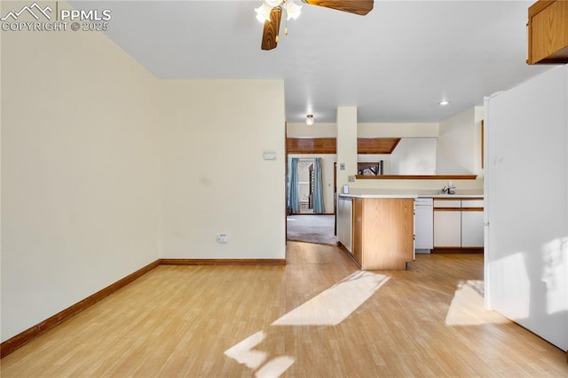 kitchen featuring light wood-type flooring, ceiling fan, and white dishwasher