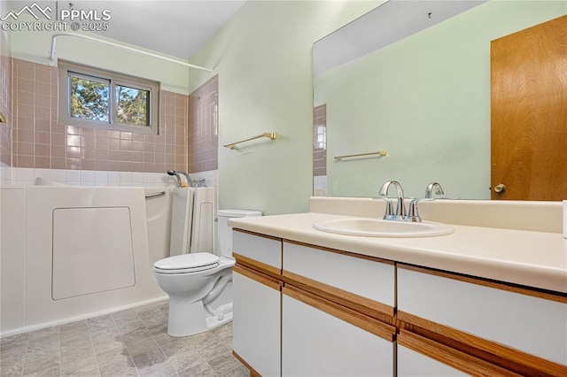 full bathroom featuring toilet, tiled shower / bath, and vanity