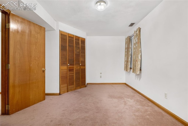 unfurnished bedroom featuring a closet and carpet floors