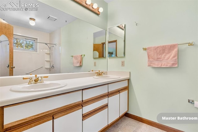 bathroom with a shower and vanity