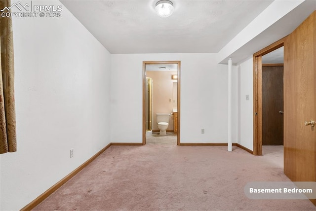 unfurnished bedroom featuring carpet floors and ensuite bath