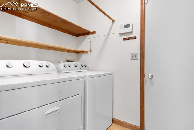 clothes washing area featuring washer and clothes dryer