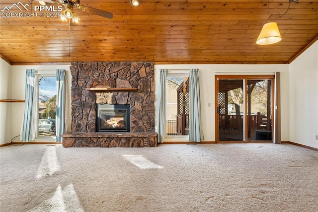 unfurnished living room with vaulted ceiling, wooden ceiling, carpet flooring, and a stone fireplace