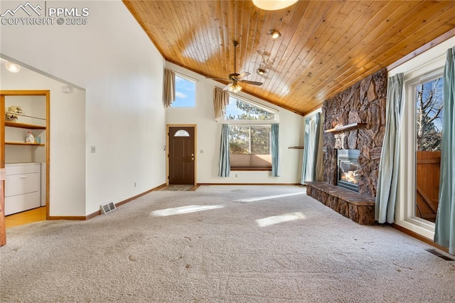 unfurnished living room featuring high vaulted ceiling, wooden ceiling, light colored carpet, and washer / dryer