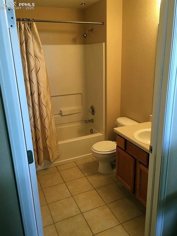 full bathroom featuring toilet, vanity, tile patterned floors, and shower / bathtub combination with curtain