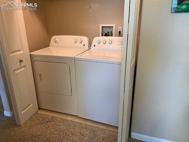 clothes washing area with light tile patterned floors and washing machine and clothes dryer