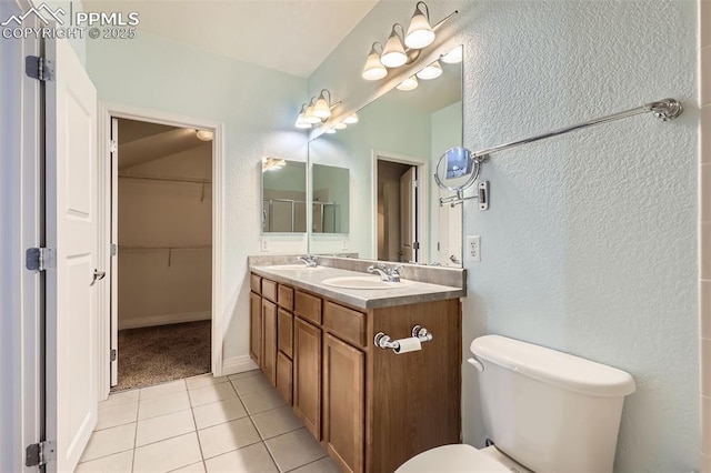 bathroom with toilet, tile patterned floors, and vanity