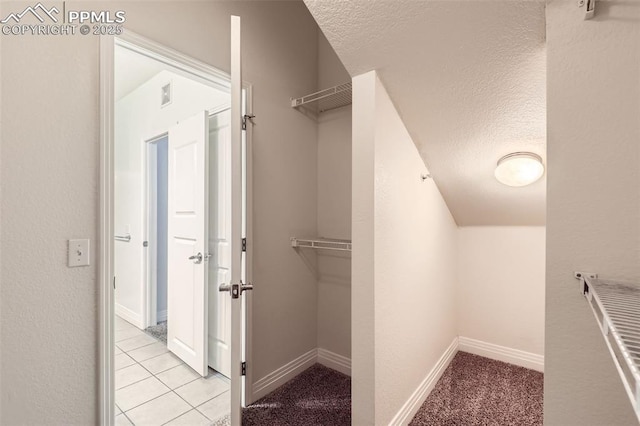 spacious closet featuring light tile patterned floors