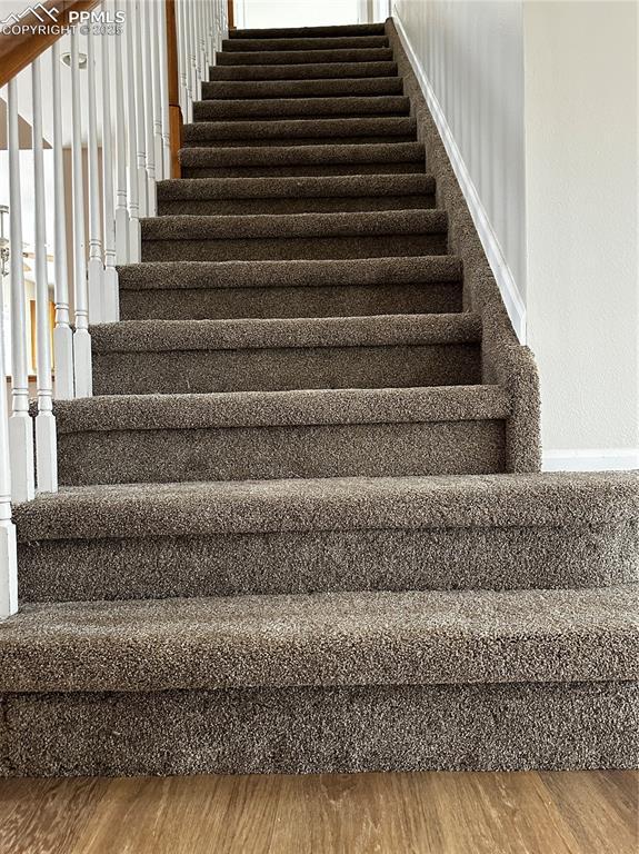 staircase featuring hardwood / wood-style floors