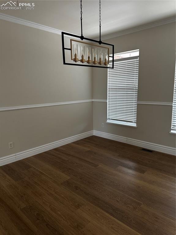 unfurnished dining area featuring crown molding and dark hardwood / wood-style flooring