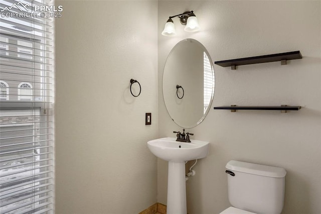 bathroom featuring a healthy amount of sunlight and toilet