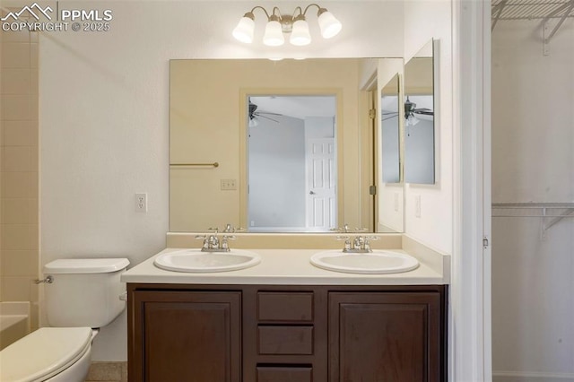 bathroom with vanity, a washtub, ceiling fan, and toilet