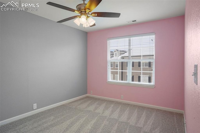 empty room featuring light colored carpet and ceiling fan