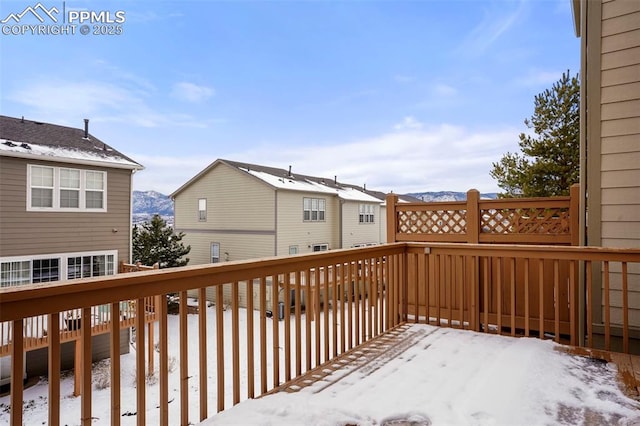 snow covered deck featuring a mountain view