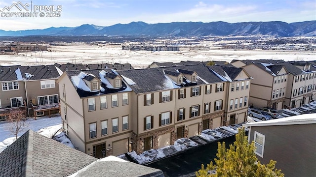 snowy aerial view featuring a mountain view