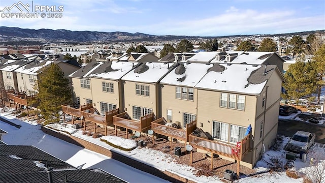 snowy aerial view with a mountain view