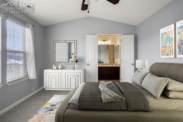 bedroom featuring lofted ceiling, connected bathroom, ceiling fan, and carpet flooring