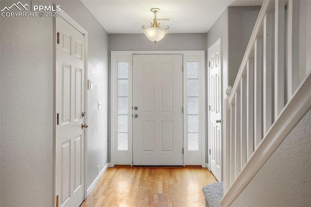 entrance foyer with a wealth of natural light and light wood-type flooring