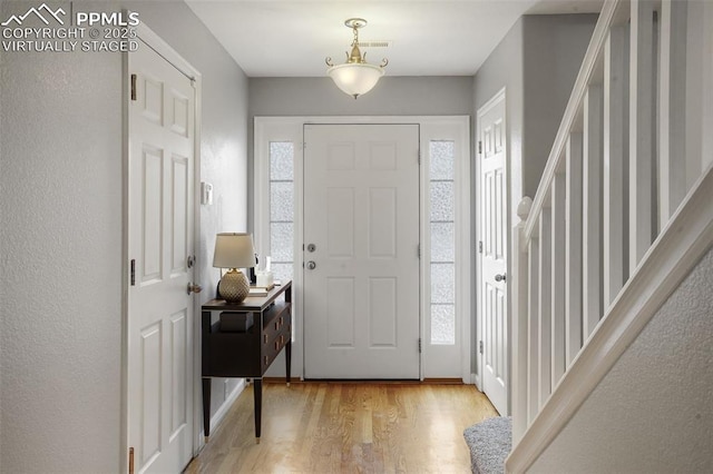 entryway with light hardwood / wood-style flooring and a wealth of natural light