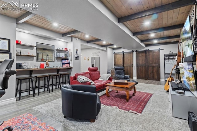 living room with wooden ceiling, beamed ceiling, a barn door, and light hardwood / wood-style flooring