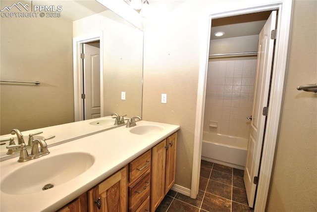 bathroom featuring vanity and tiled shower / bath