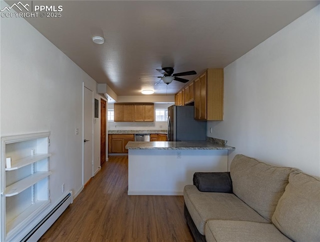 kitchen with wood-type flooring, a baseboard heating unit, stainless steel appliances, kitchen peninsula, and ceiling fan