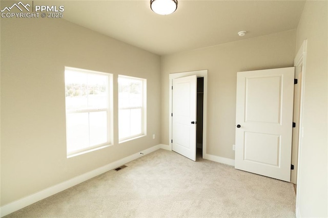 unfurnished bedroom featuring light colored carpet