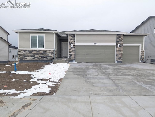 10434 Devoncove Dr, Peyton, CO 80831 - view of front of property with concrete driveway, an attached garage, and stone siding