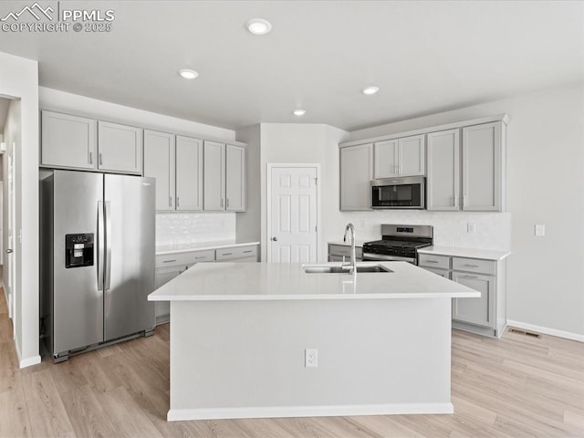 10434 Devoncove Dr, Peyton, CO 80831 - kitchen featuring appliances with stainless steel finishes, light countertops, gray cabinetry, and a sink