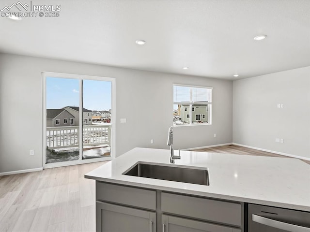 10434 Devoncove Dr, Peyton, CO 80831 - kitchen with light wood finished floors, recessed lighting, gray cabinetry, and a sink